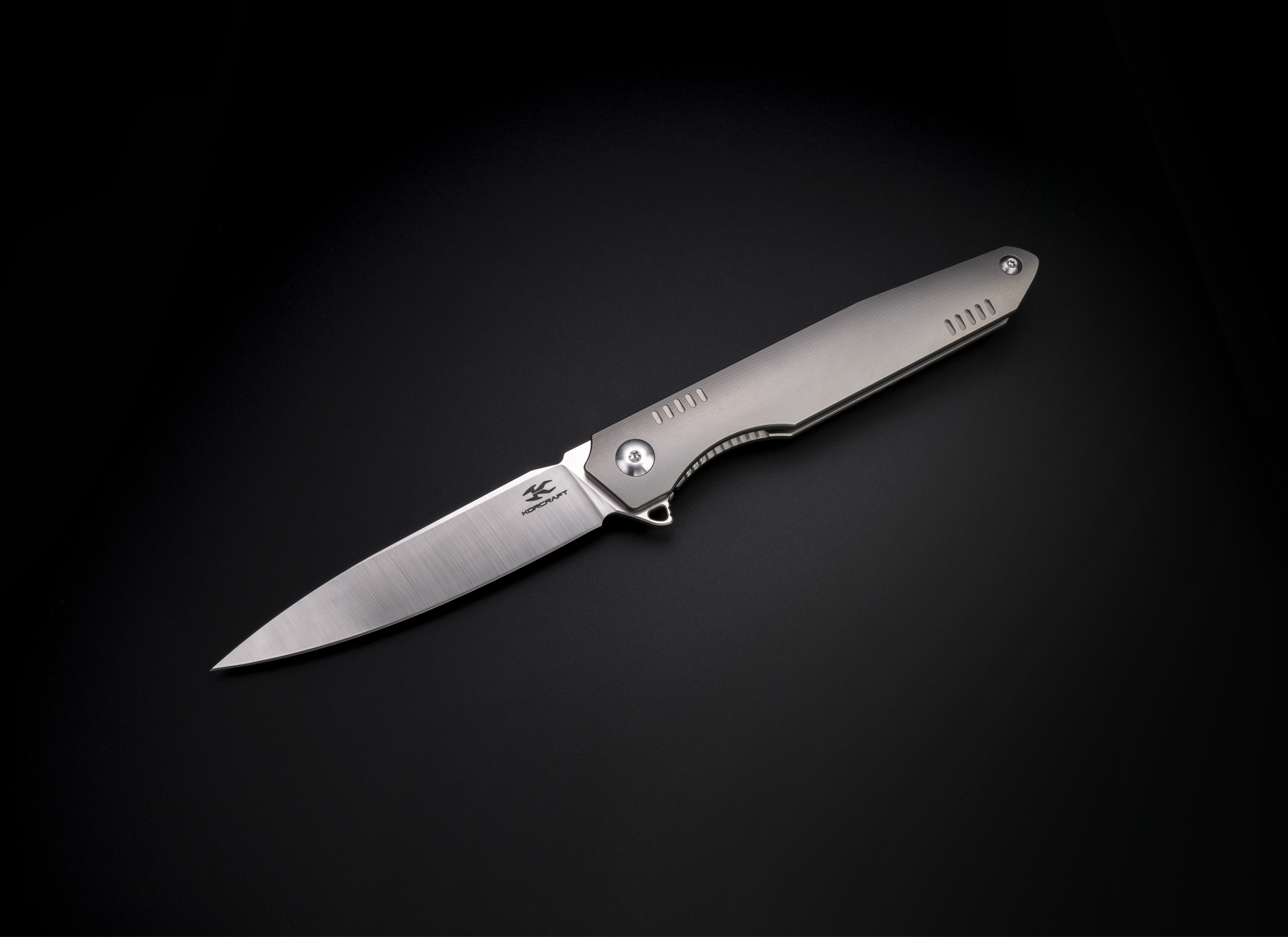The Alta by Korcraft, titanium handle and m390 blade open with pocket clip on black background