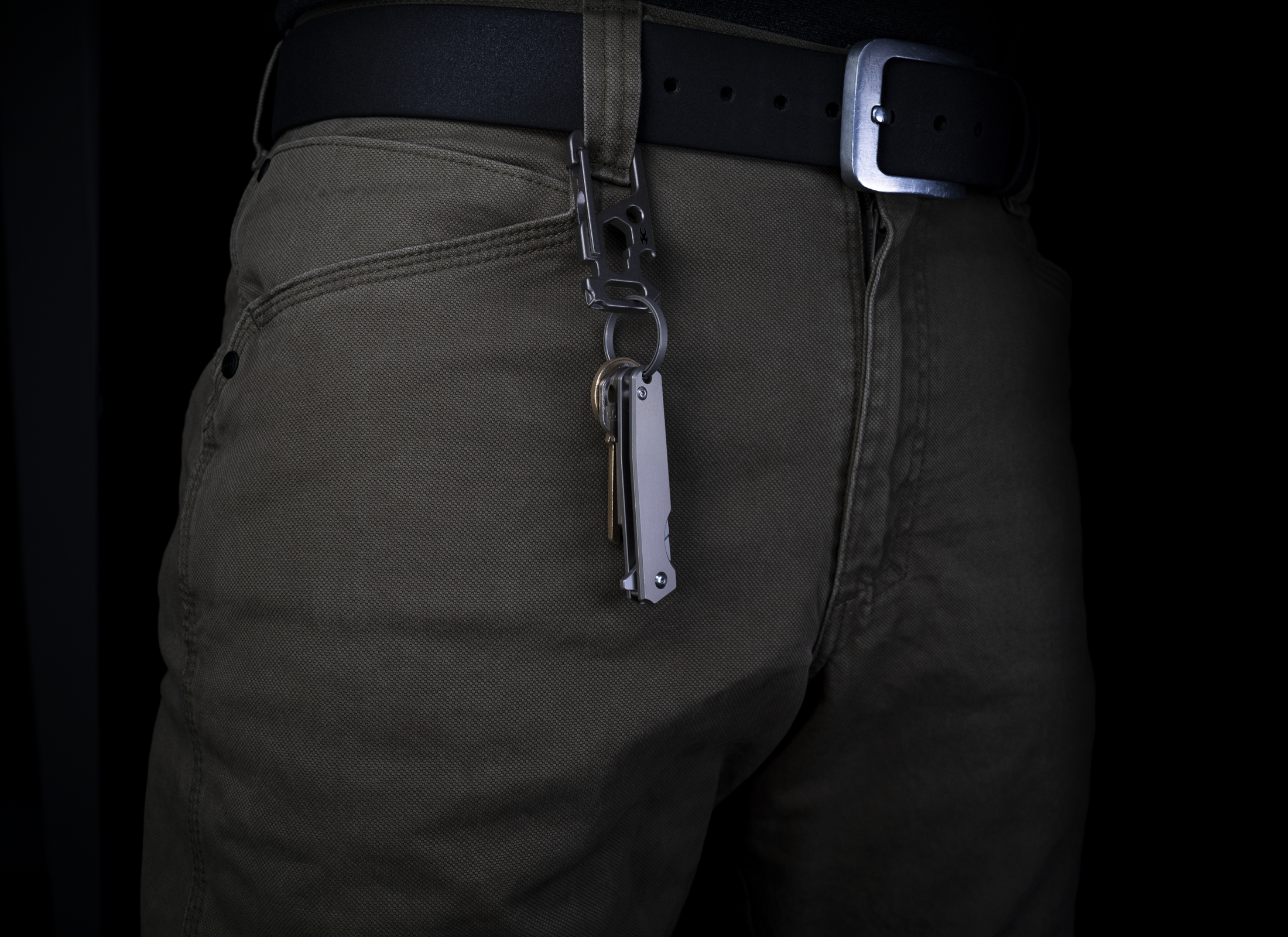 Korcraft TiBlade 01 Closed on keychain attached to jeans on Black Blackground
